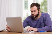 Man using his computer at home